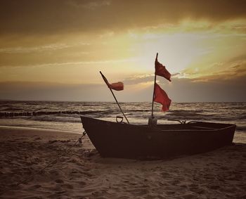 Scenic view of beach against sky during sunset