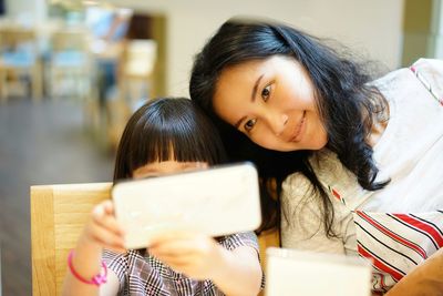 Portrait of woman holding book