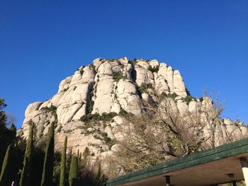 Low angle view of mountain against clear blue sky