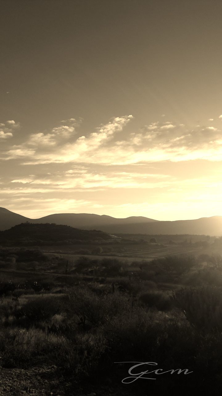 landscape, sunset, tranquil scene, tranquility, scenics, sky, beauty in nature, field, nature, mountain, silhouette, horizon over land, cloud - sky, idyllic, non-urban scene, rural scene, mountain range, remote, grass, cloud