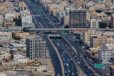 High angle view of traffic on road amidst buildings in city