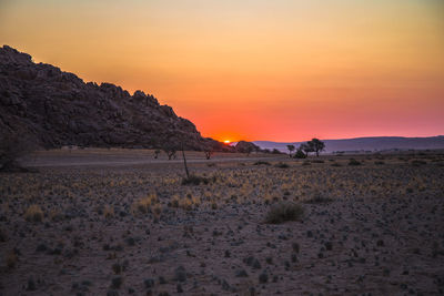 Scenic view of desert against sky during sunset