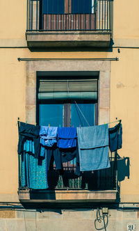 Low angle view of clothes drying against building