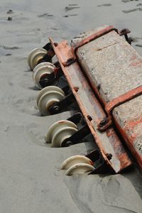 High angle view of rusty machine part on beach