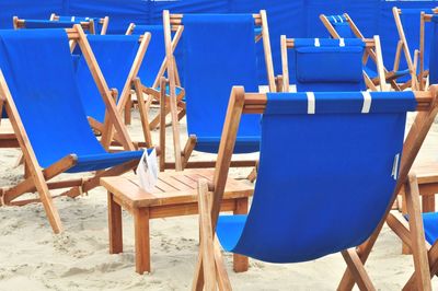 Empty chairs and tables at beach