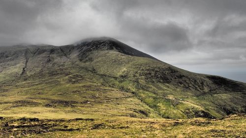 Scenic view of mountains against cloudy sky