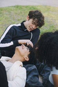 Teenage boys spending leisure time with female friend in park