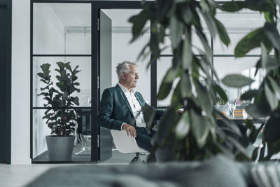 Businessman sitting on chair at office