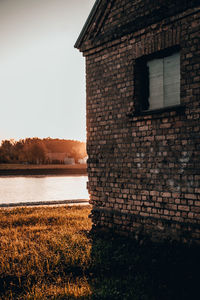 View of building by lake against sky