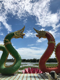 Close-up of horse sculpture against sky