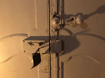 Close-up of electric lamp against wall