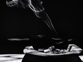 Close-up of cigarette smoking on table