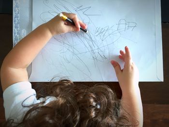 High angle view of child drawing