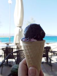 Close-up of hand holding ice cream cone