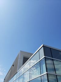 Low angle view of modern building against clear blue sky