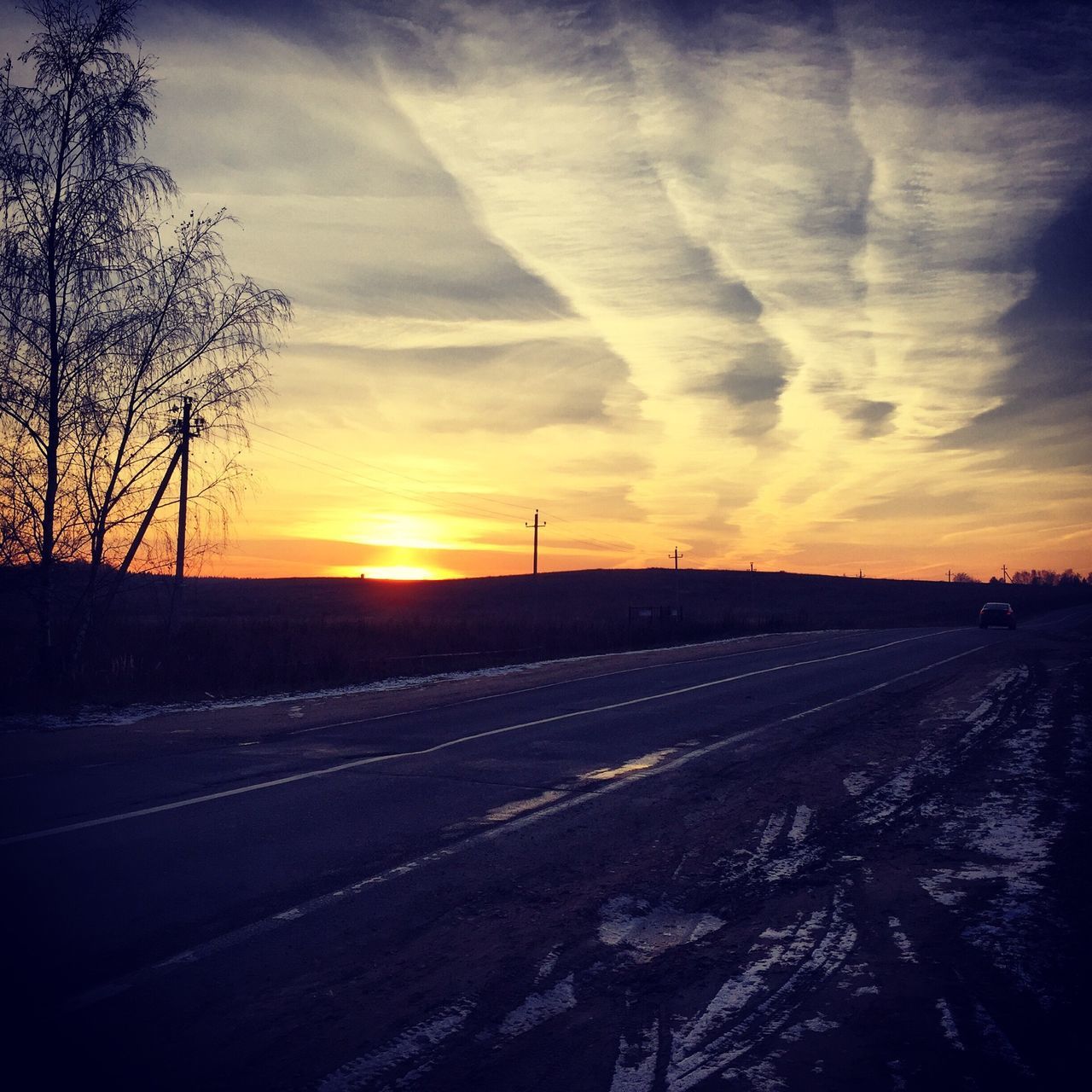 sunset, sky, landscape, tranquil scene, the way forward, tranquility, transportation, orange color, scenics, tree, road, beauty in nature, cloud - sky, snow, nature, bare tree, winter, field, diminishing perspective, vanishing point