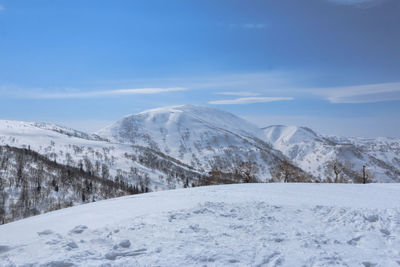 Scenic view of snow covered mountains against sky