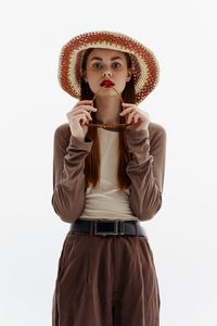 Young woman wearing hat against white background