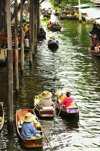 High angle view of people in boat sailing on canal