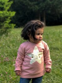 Cute girl standing on field