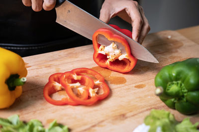 Midsection of man preparing food on cutting board