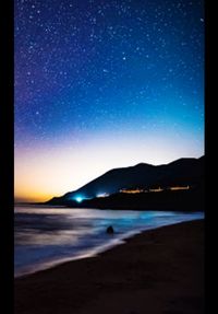 Scenic view of beach against sky at night