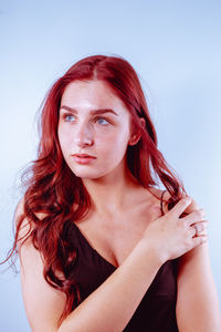 Young woman against blue background