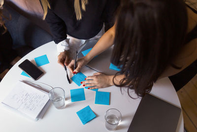 Women doing notes at meeting