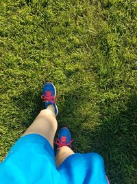 Low section of woman waking on lawn