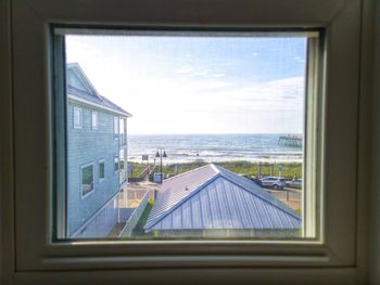 View of sea seen through window