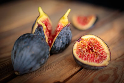 Fresh cut purple figs on a wooden background from old boards. raw exotic figs.