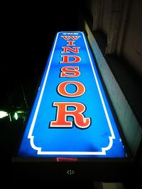 Low angle view of illuminated sign at night