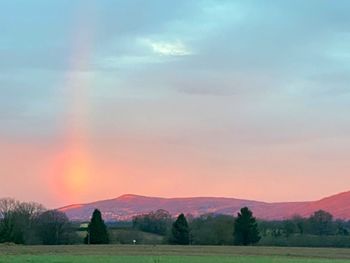 Scenic view of field against sky during sunset