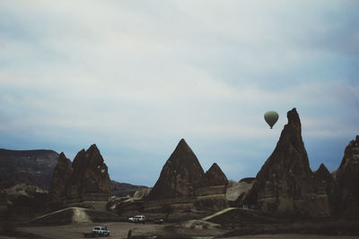 Rock formations against cloudy sky