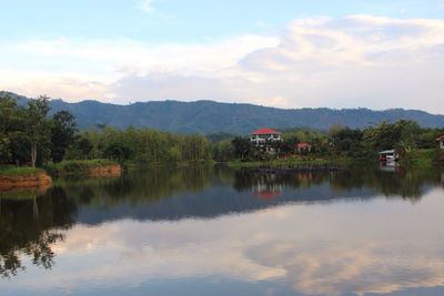 Scenic view of lake by trees against sky