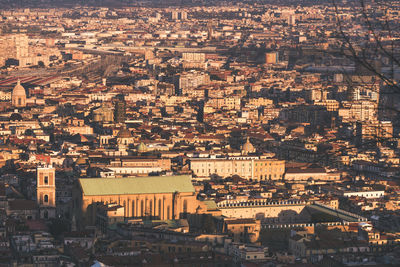 Top view of the streets of the historic center of naples with a dome illuminated by the sun