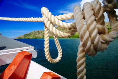Close-up of rope tied to boat sailing on sea