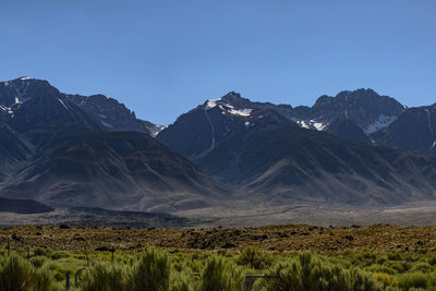 Scenic view of mountains against clear blue sky