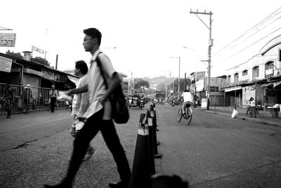 Men on city street against sky