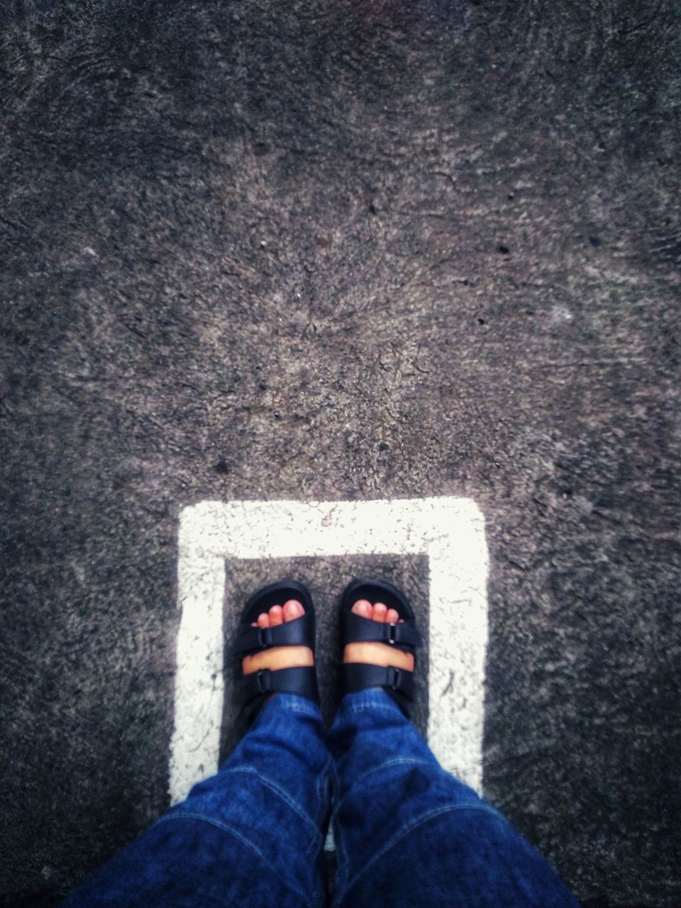 LOW SECTION OF PERSON STANDING ON STREET