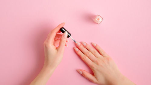 Close-up of woman hand with pink hair