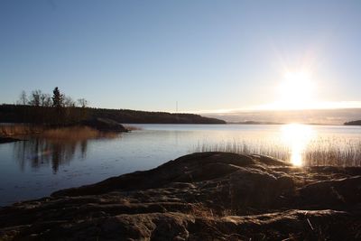 Scenic view of sea against clear sky during sunset