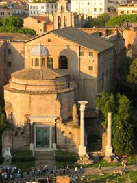 People outside the roman forum, a tourist attraction featuring ancient government buildings.