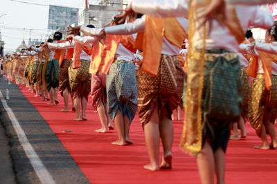 Rear view of women wearing traditional clothing while dancing outdoors