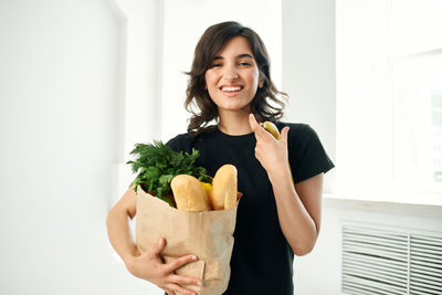 Portrait of a smiling young woman holding ice cream