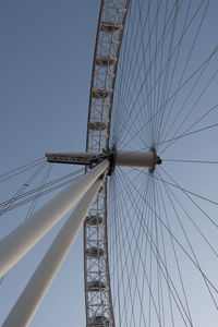 Low angle view of ferris wheel against blue sky