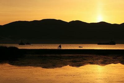 Scenic view of sea against orange sky