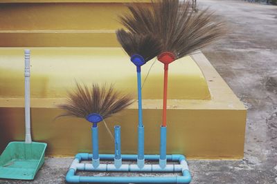 Close-up of paintbrushes in container against wall