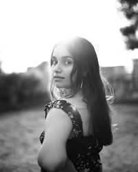 Portrait of young woman standing outdoors