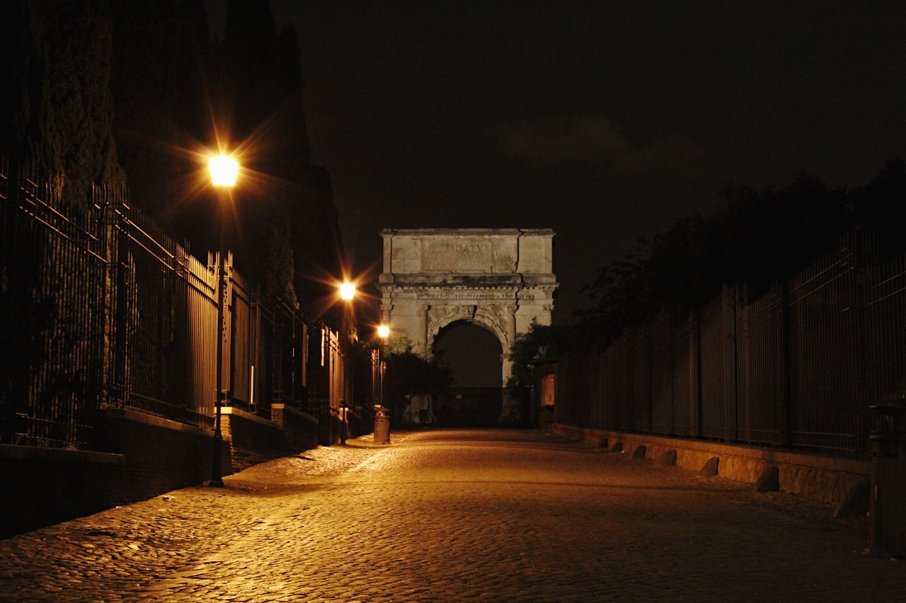 illuminated, architecture, built structure, the way forward, night, arch, street light, diminishing perspective, building exterior, lighting equipment, empty, vanishing point, street, road, transportation, city, long, sky, walkway, no people